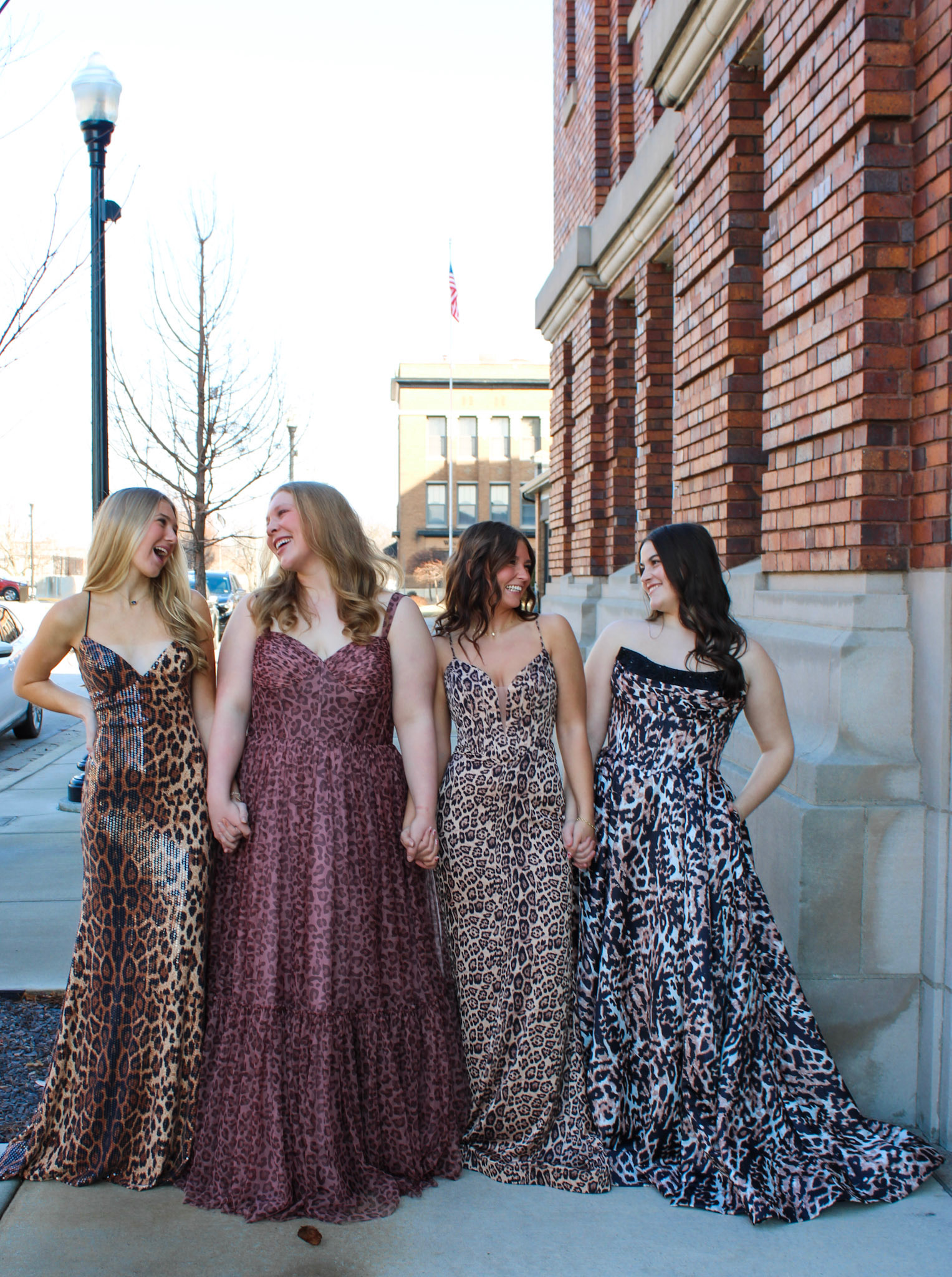 Four friends in printed formal gowns